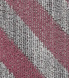 a close up view of a red and grey rug