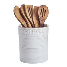 several wooden utensils in a white container