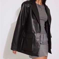 This Jacket Is Oversized And Features A Material In Pu And A Classic Collar. It Has Slightly Padded Shoulders, A Snap Button Closure And A Flap Pocket With A Snap Button. Size Listed As 36 (Women’s Small) Winter Workwear Leather Jacket With Pockets, Winter Outerwear With Faux Front Pockets For Night Out, Black Outerwear With Faux Front Pockets For Night Out, Winter Outerwear For Night Out With Faux Pockets, Trendy Workwear Outerwear With Multiple Pockets, Fall Workwear Blazer With Multiple Pockets, Oversized Outerwear For Night Out, Long Leather Jacket With Pockets For Work, Blazer With Lapel Collar And Pockets For Night Out