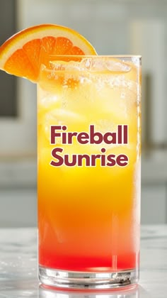 a fireball sunrise cocktail with an orange slice on the rim