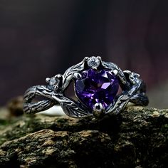 Crafted from sterling silver, our Men's Wedding Ring with Celtic Tree Bark is a nature-inspired and enchanting piece that combines celtic motifs with the magic of the forest. Adorned with an amethyst and featuring intricate details reminiscent of tree bark, this ring captures the essence of an elvish engagement and the enchantment of the forest. Ideal for those seeking a fantasy magical ring or forest jewelry. Characteristics: Metal - Recycled solid sterling silver  Stone - Cubic Zirconia Finish - Oxidized. View all silver celtic engagement rings: https://www.etsy.com/shop/TinyShinyJewel?ref=seller-platform-mcnav&section_id=44336419 Care instructions: To care for the ring, avoid contact with water and chemicals such as perfumes and lotions. When the ring is not in use, store it in a dry, c Mystical Crystal Promise Ring, Magical Gemstone Ring For Anniversary, Mystical Rings With Accent Stones For Anniversary, Magical Sterling Silver Rings For Anniversary, Mystical Anniversary Rings With Accent Stones, Mystic Anniversary Ring With Accent Stones, Heart Shaped Amethyst Jewelry For Wedding, Gothic Heart-shaped Wedding Jewelry, Heart-shaped Amethyst Wedding Jewelry