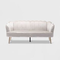 a white couch sitting on top of a wooden frame