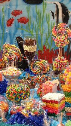 a table filled with lots of candy and lollipops