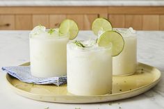 three glasses with limeade on a plate