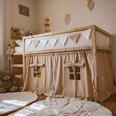 there is a bunk bed with curtains on it and a teddy bear in the corner