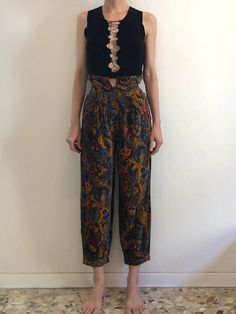 Wonderful 1980s Kenzo harem pants.  I think probably based on traditional Japanese trousers. These are so good.  First the fabric - a super fine corduroy with a velvet touch.  The pants have four pleats on each side in the front. The back has darts for shape.  High waist with a section that rises above the waist band - for a kind of paper bag waist band.  Four button exposed fly.  Side seam pockets! Pant leg is wide and full.  At the hem the leg is gathered into pleats and finishes with a cuffed band.  Wonderful psychedelic paisley floral pattern.  Label Kenzo Jungle, Paris. Made in France. Size 36.  Fabric is 100% cotton. Wash cool water, drip dry.  Great vintage condition with no fabric or sewing flaws.  Measurements Waist 65cm/ 25.5inches Hips 116cm/ 45inches Rise 31cm/ 12inches Waist t Japanese Trousers, Corduroy Pants Men, Paisley Pants, Full Midi Skirt, Vintage Woolrich, Womens Trousers, Cheerleading Outfits, Corduroy Shorts, Streetwear Mens