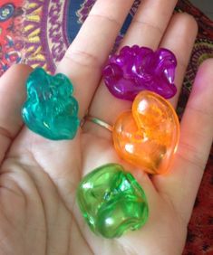 three gummy bears are sitting in the palm of someone's hand with their fingers