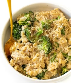 a white bowl filled with macaroni and cheese covered in broccoli florets