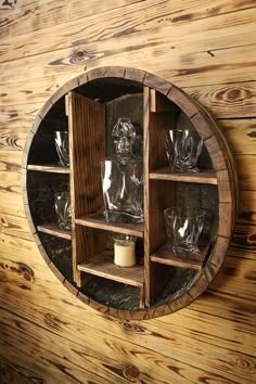 a round wooden shelf with glasses on it