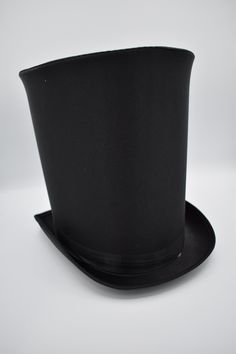 This season complete your look with this Extra Tall Satin Top Hat in Black. Featuring a black top hat that stands approximately 10 inches tall. Perfect for Halloween, Cosplay, Theater, Prom and More! Each magician hat is sized about 50cm - 57 cm or 22.4 inches in circumference and includes a sweatband. This satin top hat has a matching satin band that rounds the base of the hat accented with a upturned brim on the sides. Ringmaster top hat is about 11.5 inches long and 9.5 inches wide. *Inside of hat does not extend to the top. There is a "false" top layer.*  Great for Men and Women! This hat is great for many purposes including Steampunk, Victorian, Theatrical use, Formal occasions, weddings, Coachman, Jack the Ripper, Ring Master, and more. For ages 14 and older. Spot clean only. One siz Victorian Prom, Magician Hat, Black Satin Top, Ring Master, Tall Hat, Black Top Hat, Steampunk Victorian, Bowler Hat, Prom Formal