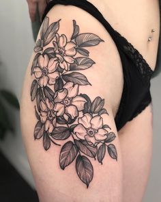 a woman's thigh with flowers on it