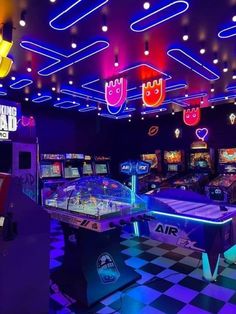 a room filled with arcade machines and neon lights