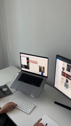 a person sitting at a desk with two computer screens