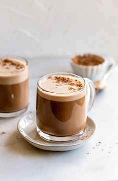 two glasses of hot chocolate on a plate