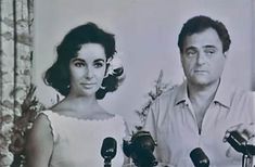 an old black and white photo of a man and woman in front of microphones