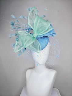 From the 2024 Featured Milliner of the Kentucky Derby Museum  Gorgeous Kentucky Derby hat fascinator  kentucky derby hat fascinator baby blue sinamay w/ mint green mesh wired ribbon large bow decor, teal blue branching feathers w/ mesh veil headband attachment each hat is totally one of a kind! no two are alike! I can probably add feathers, flowers etc to existing hats for a small fee. I cannot remove anything from existing hats. Just message me and see if we can make it work! :) I cannot make custom order from scratch. My schedule is unfortunately too crazy :( *All hats are sold as displayed. No returns do to nature of product (headwear) Of course do not hesitate to contact me with any issues :) Check out my The Hat Doctor amazing news story feature!! https://www.wdrb.com/derby_148/kentuc Veil Headband, Derby Hats Fascinators, Hat Fascinator, Kentucky Derby Hat, Bow Decor, Derby Hat, Large Bow, Derby Hats, Wired Ribbon