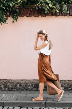 "Knee-length wrap linen skirt with a higher waistline. This midi linen skirt fastens with a crossover front, super easy to slip in and slip out. The A-line silhouette and lightweight linen fabric ensure elegance and comfort all year round. Available in cinnamon Please note that due to the many variations in monitors and browsers, actual colors may vary. DETAILS * Model wearing Cinnamon in size S is 5'10\" (178 cm) * Made from 100% European linen * Stone washed for maximum softness * OEKO-TEX cer Linen Wrap Skirt, Wrinkled Clothes, Wrap Clothing, Linen Tank Top, Linen Tank, Skirt Midi, Dark Wear, Linen Skirt, Linen Top