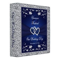 a blue and silver wedding binder with two hearts