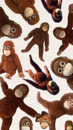 several stuffed monkeys with different facial expressions on their faces and hands, all in various poses