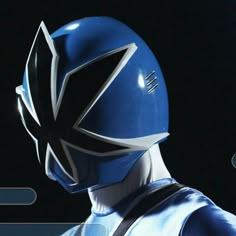 a close up of a person wearing a blue and white helmet with the word power rangers on it