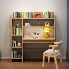 a wooden desk and chair in front of a bookshelf