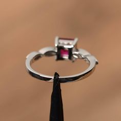 It is a lab ruby ring, princess cut, measures 6mm*6mm, weight about 1.37 cts. The basic metal is sterling silver and plated with rhodium. To change the metal to a solid gold (white/rose) or platinum is also available, please ask for a quotation if you want. You can also go to my shop Home for more elegant rings: https://www.etsy.com/shop/godjewelry?ref=hdr_shop_menu ruby is birthstone of July More ruby rings: https://www.etsy.com/shop/godjewelry?ref=seller-platform-mcnav&section_id=20709238 Asscher Cut Ruby Ring With Prong Setting For Anniversary, Asscher Cut Ruby Jewelry With Center Stone, Silver Emerald Cut Ruby Ring With Halo Setting, Ruby Jewelry With Asscher Cut For Anniversary, Square Cut Ruby Jewelry Fine Jewelry, Square Cut Ruby Ring Fine Jewelry, Princess Cut Ruby Ring In White Gold For Anniversary, Asscher Cut Ruby Ring For Anniversary, Anniversary Princess Cut Ruby Ring In White Gold