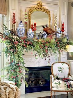 a fireplace decorated for christmas with greenery and birds sitting on top of the mantel