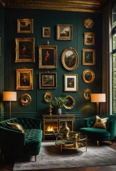 a living room filled with green couches and pictures on the wall above them in gold frames