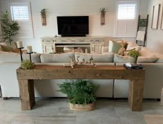 a living room filled with furniture and a flat screen tv mounted to the side of a wall