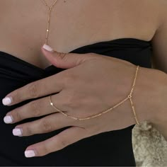 Dainty 18k gold plated/platinum plated hand chain. Our hand chain is so flattering and comfortable to wear. Our chain is sparkly and sits so beautifully on the hand. Layer with some of your favourite rings and bracelets. We have always been obsessed with hand chains so we created our own. Hand chains are so dainty and give that extra sparkle and shine to your hands. Measurements:  Bracelet - 6.5-7" inches (comes with extra adjustable 2" chain extender) Wrist to finger - 7 cm Please feel free to Finger Chain Bracelet, Permanent Hand Chain, Gold Chain Ring For Party, Elegant Adjustable Chain Link Ring, Minimalist Link Jewelry For Party, Elegant Gold Chain Adjustable Ring, Elegant Adjustable Gold Chain Ring, Minimalist Chain Ring For Parties, Minimalist Adjustable Chain Ring For Party