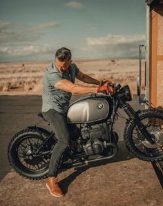 a man sitting on the back of a motorcycle