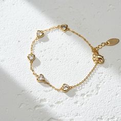 The Lots of Love Bracelet is a heartfelt ode to affection and warmth. Crafted from 18K gold plated brass, this piece is a tangible representation of love's enduring bond. It's a reminder that love comes in many forms, each one precious and worth cherishing. Wear it as a symbol of the love you give and the love you receive, a circle of joy that envelops your wrist. PRODUCT DETAILS Materials: 18K Gold Plated, 316L Stainless Steel Bracelet Length: 6.7 - 8 inch / 17-20.5 cm Includes bracelet Gold Promise Bracelets With Heart Charm, Valentine's Day Tarnish Resistant Brass Jewelry, Dainty Gold-tone Bracelets For Gift, Dainty Gold-tone Bracelets As Gift, Elegant Brass Jewelry For Valentine's Day, Adjustable Silver Heart Bracelet Gold Plated, Gold Promise Bracelet For Valentine's Day, Adjustable Plated Chain Bracelet As Gift, Adjustable Plated Chain Bracelet For Gift