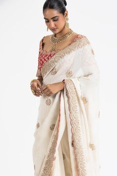 Ivory georgette saree featuring scattered floral butti embroidery. Paired with a padded blouse showcasing gota, zari, dabka, beads, and resham work., Fit: Relaxed Off White Blouse Piece For Wedding And Diwali, Wedding Blouse With Chikankari Embroidery In Tissue Silk, White Chikankari Embroidery Blouse For Reception, White Blouse With Chikankari Embroidery For Reception, Off White Wedding Saree With Unstitched Blouse, Festive Elegant Off-white Blouse Piece, Reception Blouse With Chikankari Embroidery In Traditional Drape, Chanderi Blouse For Wedding With Traditional Drape, Wedding Chanderi Blouse With Traditional Drape