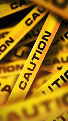 yellow caution tape with the word caution printed on it in black and white letters,