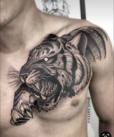 a man with a tiger tattoo on his chest