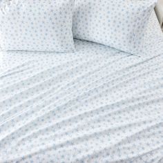 a white bed with blue stars on it