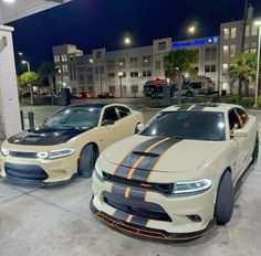 two cars parked next to each other in a parking lot