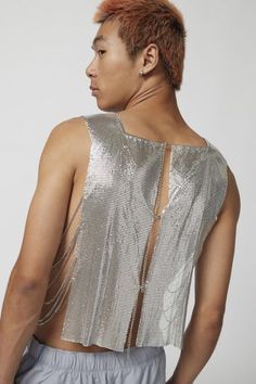 Troye metal tank top in a sleeveless style with an open back and cropped fit. Content + Care Mixed metals Wipe clean Imported Size + Fit S/M Dimensions Chest: 26" + 6" extender Length: 22" L/XL Dimensions Chest: 30.5" + 6" extender Length: 22.5" | Troye Metal Tank Top in Silver, Men's at Urban Outfitters Silver Sleeveless Crop Top For Evening, Silver Tank Top For Summer, Silver Sleeveless Tank Top For Summer, Metallic Sleeveless Crop Top For Evening, Silver Sleeveless Crop Top For Night Out, Summer Evening Tank Crop Top, Fitted Silver Sleeveless Crop Top, Urban Outfitters Fitted Sleeveless Tank Top, Metallic Crop Top For Summer Evenings