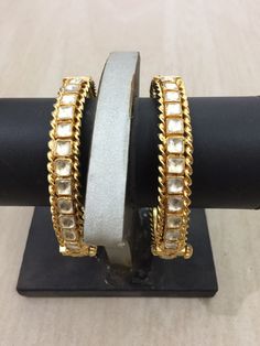 *This is Gold Finish Kundan Bangles pair.Its Perfect for Wedding Occasion as well as Unique and Ethnic Traditional Bangle to gift and Also Bridal wear to match with Wedding Outfits. *Its made from Silver n Copper mix material and 100% Handmade. *Its available in Various Sizes like 2,2.2,2.4,2.6 Etc Its white kundan combination like shown in picture. *Its open able Screwed Bangles Pair. *All Kundan stones set with silver foils handsetting method and long last guarantee of its workmanship.It is Wh Festive Bangle With Intricate Design For Reception, Kundan Meenakari Bangle For Reception, Reception Kundan Bangle With Meenakari, Meenakari Kundan Bangle For Reception, Reception Meenakari Kundan Bangle, Formal Gota Work Jewelry For Diwali, Temple Jewelry Style Tilla Bangle For Reception, Gold Bracelet With Stone Work For Reception, Cutdana Bangle Jewelry For Reception