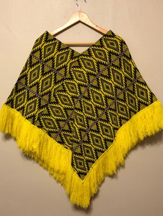 "Eye catching Vintage Citrine yellow, black and lavender poncho.  Would be perfect for Mardi Gras! One size, fits most. Measurements: Length: 34\" from shoulder to bottom of fringe. Width: 33\" Fabric: Cotton/Polyester blend" Yellow Bohemian Poncho One Size, Bohemian Yellow Poncho One Size, Yellow Bohemian Poncho For Fall, Yellow Bohemian One-size Poncho, Yellow Bohemian One Size Poncho, Hand Painted Pillows, Fuschia Dress, Cotton Blazer, Knitted Poncho