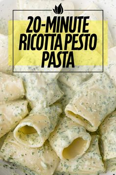 a bowl filled with ravioli and sauce next to a yellow sign that says 20 - minute ricotta pesto pasta