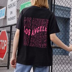 Nwt Graphic Oversized Tee Los Angeles Written On It Black Shirt W/ Pink Writing. This Is Trendy And In Style Right Now For Sure! Trendy Pink Tops For Streetwear, Black Slogan Urban Tops, Black Urban Slogan Top, Urban Black Slogan Top, Pink Screen Print Tops For Streetwear, Casual Pink Shirt With Letter Print, Pink Relaxed Fit Top For Streetwear, Pink Slogan T-shirt For Streetwear, Pink Text Print T-shirt For Streetwear