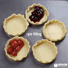 four pie pans with different types of pie filling