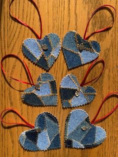 denim heart ornaments are arranged on a wooden table