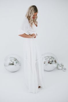 Instantly become the most adored, this stunning maxi features a cinched waistline, cuffed mid-length sleeves, full lining, and intricate lace detailing throughout. The most whimsical piece for all seasonal occasions! Neckline: Lace V Fabric: 100% polyester; Lining: 100% Polyester Details: Cinched waistline, lined, mid-length cuffed sleeve, lace detailing, adjustable tie back Fit: True to size, if in between sizes we recommend sizing down! - Arms: Relaxed; Mid-length cinched sleeve- Chest: Relaxe Chic V-neck Dress For Beach Wedding, White Fitted V-neck Maxi Dress, Chic Solid Color Wedding Dress, White V-neck Fitted Maxi Dress, White V-neck Midi Dress For Wedding, Chic White Maxi Dress For Wedding, Chic Flowy Dress For Beach Wedding, Chic White Beach Wedding Dress, Chic White Dress For Beach Wedding