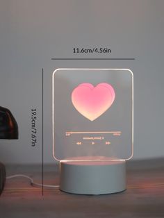 a heart shaped light up on top of a table