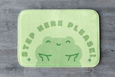 a green frog rug with the words sleep here pleases