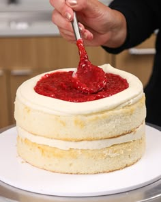 a person is spreading icing onto a cake