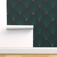 an art deco style wallpaper with green fan pattern on the back and gold accents