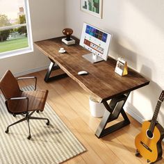 a computer desk with a guitar on top of it